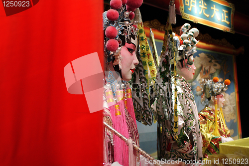 Image of chinese opera dummy and red cloth as text space ,it is a toy,not