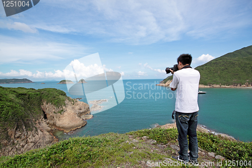 Image of photographer takes a photo of the landscape 