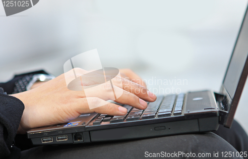 Image of Hands typing on laptop computer keyboard close up