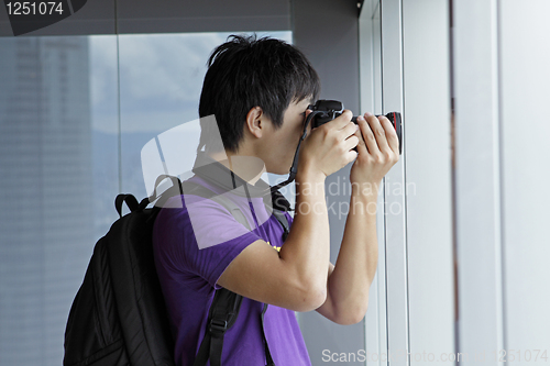 Image of photographer takes a photo of the landscape indoor