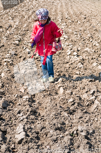 Image of Cute child girl with ice cream playing in the field
