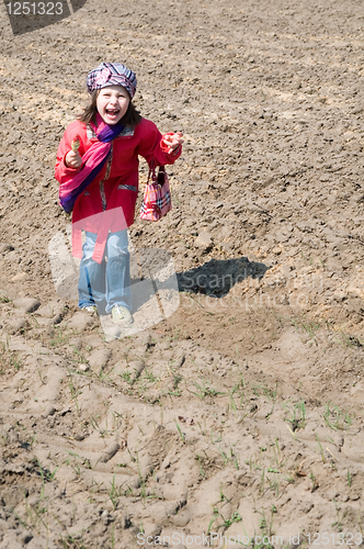 Image of Cute child girl with ice cream playing in the field