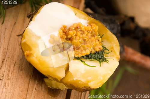 Image of Baked potato with sour cream, grain Dijon mustard and herbs