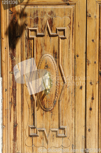 Image of Wooden door with door knocker