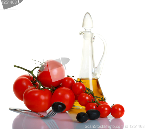 Image of Black olives on a background of ripe tomatoes.