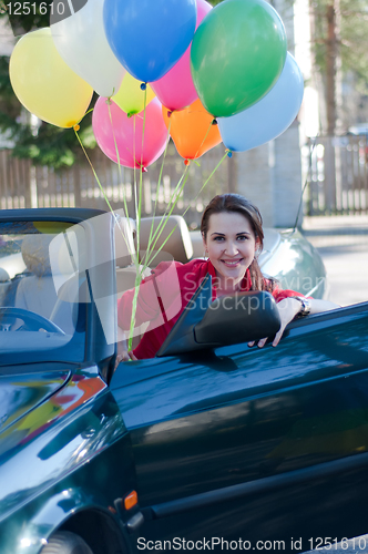 Image of Beautiful brunette woman in car