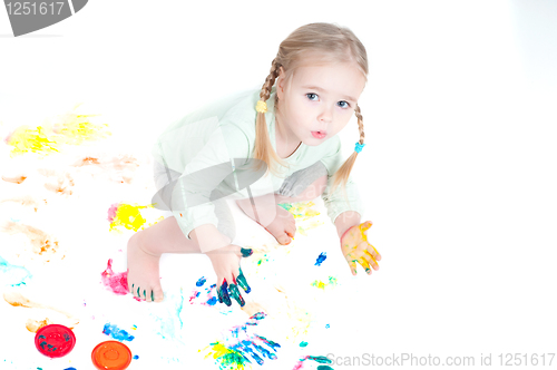 Image of Little girl playing with colors