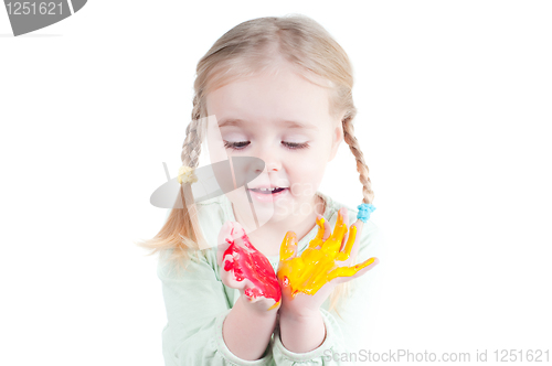 Image of Little girl playing with colors