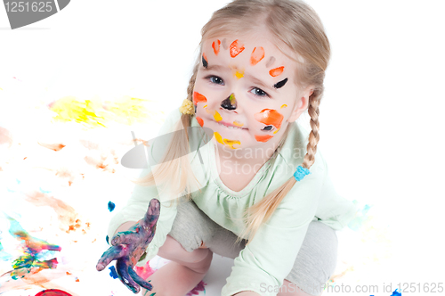 Image of Little girl playing with colors