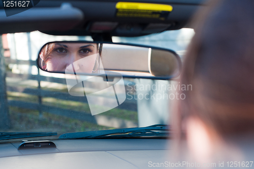 Image of Beautiful brunette woman in car