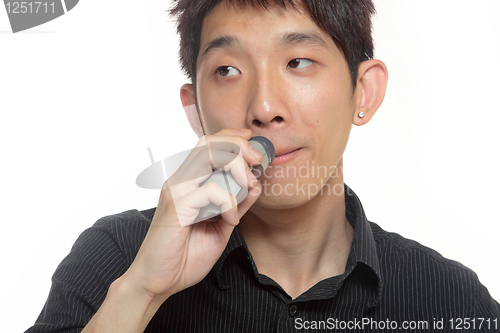 Image of young man shaving his beard off with an electric shaver 