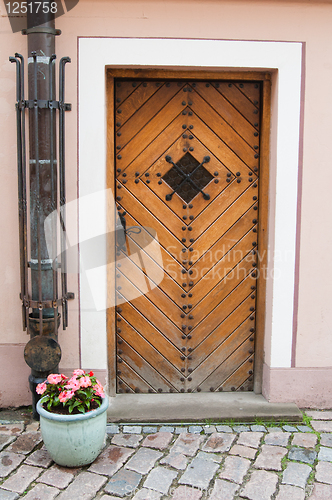 Image of Old door and vase with flowers