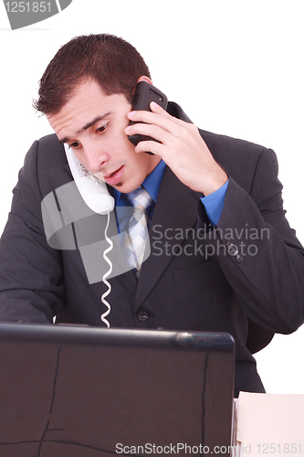 Image of Isolated Stressed Businessman At His Desk Working