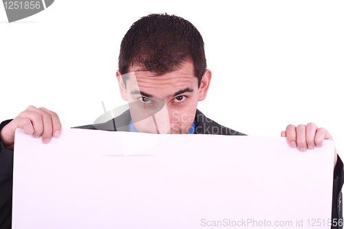 Image of Young man, looking down to a blank board. 