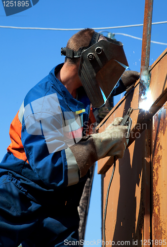 Image of A welder working at height