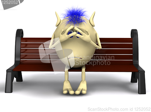 Image of Haired shamed puppet sitting on brown park bench