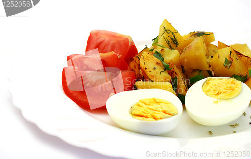 Image of Tomatoes laying next to potatoes and eggs
