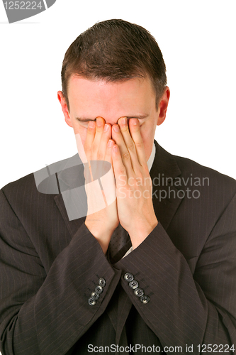 Image of Businessman hiding his face in shame