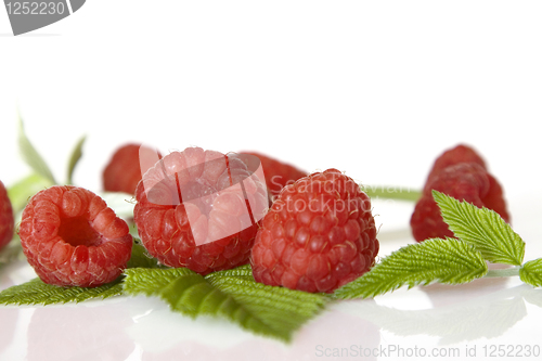Image of Ripe raspberry with green leaf