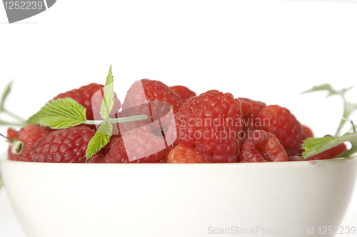 Image of Ripe raspberry with green leaf