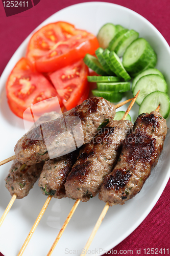 Image of Arab lamb kofta on a plate vertical