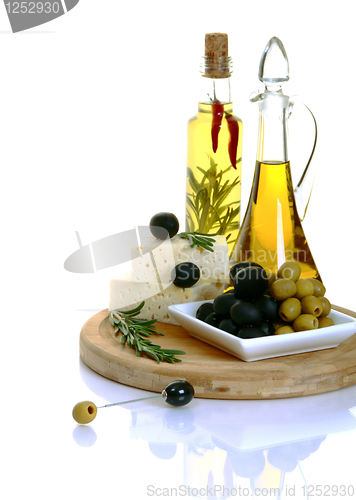 Image of Feta, black olives and green olives with rosemary. 