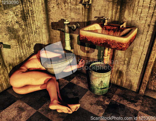 Image of Naked man lying next to a toilet