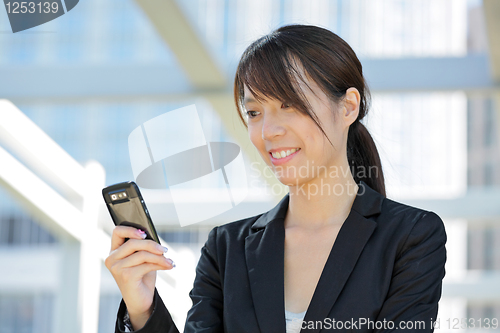 Image of business woman using mobile cell phone