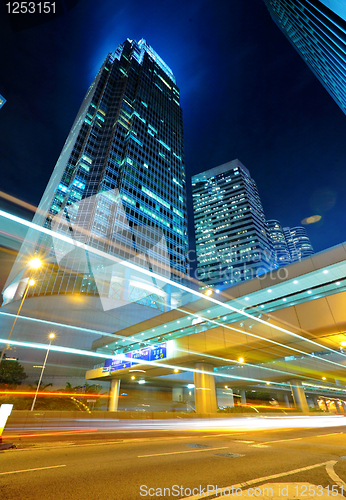 Image of light trails on the modern building background