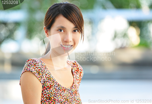 Image of young woman smiling friendly