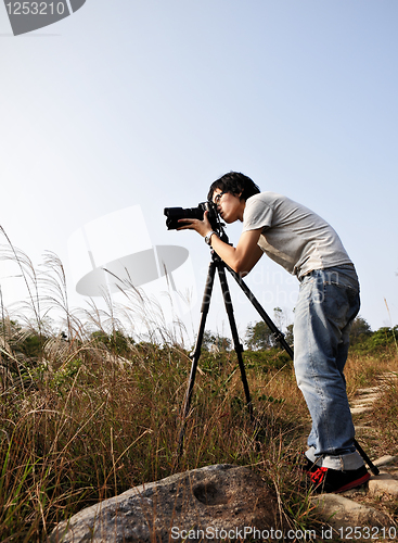 Image of Photographer taking photo at wild