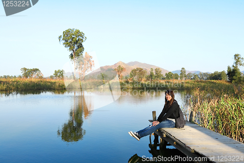 Image of girl on pier at lake