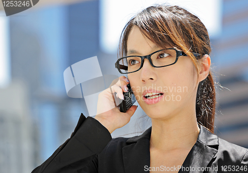 Image of young business woman with mobile phone