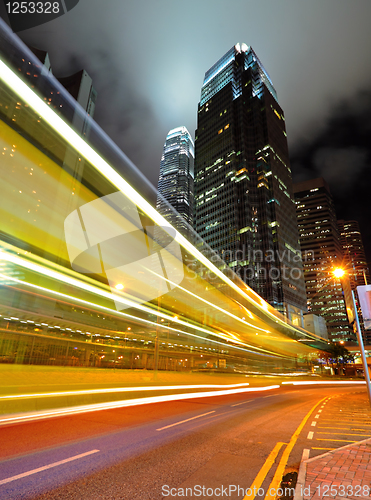 Image of light trails on the modern building background