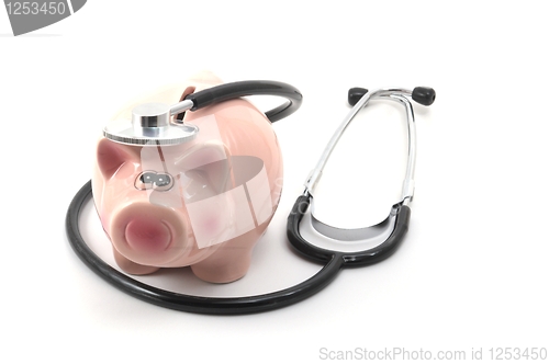 Image of stethoscope and piggy bank