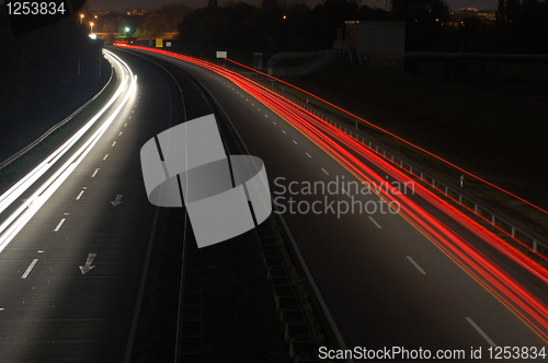 Image of road with car traffic at night with blurry lights