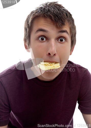 Image of Boy mouthful potato chips