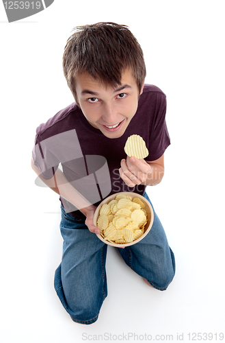 Image of Boy eating potato crisp chip snack