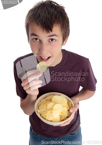 Image of Boy eating chip snack and looking up