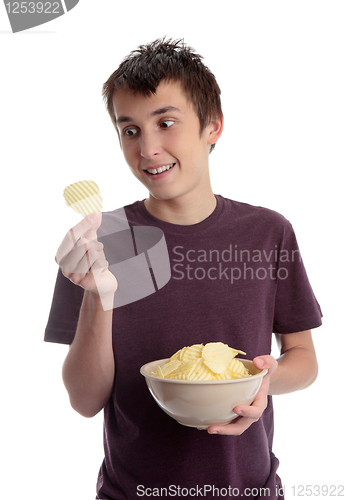 Image of Boy holding potato crisp and smiling