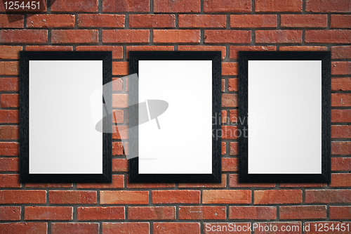 Image of Frames on red brick wall