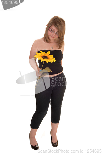 Image of Teen holding sunflower.