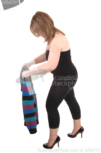 Image of Girl folding her jacket.    