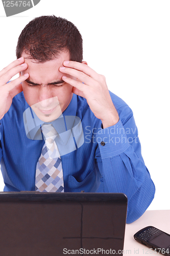 Image of male frustrated with work sitting in front of a laptop. 