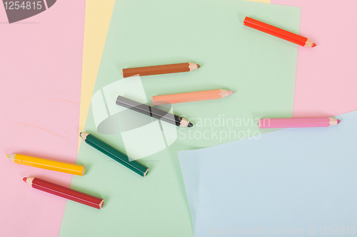 Image of Color pencils and paper on children desk