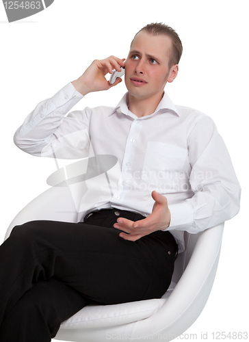 Image of A businessman in a conversation on the phone solves the problem