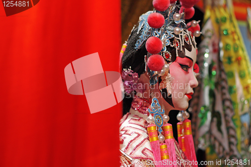 Image of chinese opera dummy and red cloth as text space ,it is a toy,not