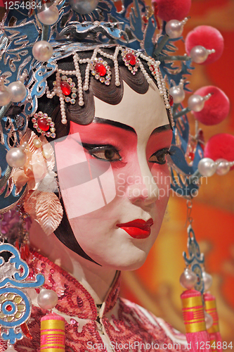 Image of chinese opera dummy and red cloth as text space ,it is a toy,not