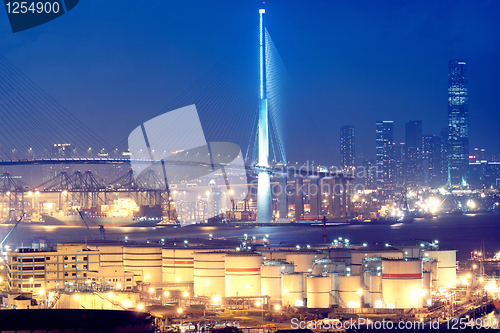 Image of gas container and bridge at night