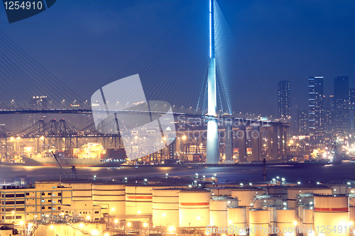 Image of gas container and bridge at night